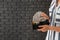 Young woman with wallet full of money against dark brick wall, closeup