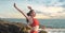 young woman is warming up before practicing yoga on the beach by the ocean