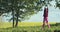 Young woman warming up stretching outdoors in countryside slow motion. Sportive girl doing sport fitness on fresh air