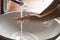 Young woman washing hands over bathroom sink, close up view