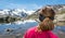 Young woman watching mountain lake