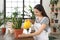 Young woman watering beautiful plant