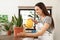 Young woman watering beautiful plant