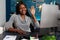 Young woman waving at video call camera on computer