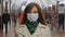 Young woman wear face protective mask looking at camera, timelapse