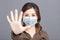 Young woman  wear medical mask and showing no and stop sign gesture. keep away, Social distance