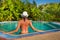 Young woman wearing bikini in small pool