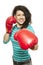 Young woman wearing boxing gloves smiling