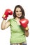 Young woman wearing boxing gloves smiling