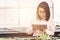 A young woman wearing a checkered shirt is checking sales progress on a tablet at the cactus. A beautiful Asian woman looks at her