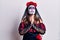 Young woman wearing day of the dead costume over white begging and praying with hands together with hope expression on face very