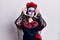 Young woman wearing day of the dead costume over white smiling cheerful playing peek a boo with hands showing face