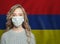 Young woman wearing a face mask with flag Armenia. Flu epidemic and protection concept