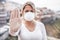 Young woman wearing face mask and latex gloves while showing stop hand gesture for coronavirus prevention -  Stop spreading Covid