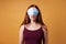 Young woman wearing medical face mask over her eyes - corona denier