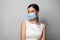 Young woman wearing medical face mask, studio portrait