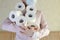 Young woman at wearing protective mask hold in hands a heap of toilet paper. Toilet paper crisis due to coronavirus COVID-19