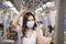 An young woman is wearing protective mask in metro , covid-19 protection , safety travel , new normal , social distancing , safety