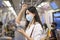 An young woman is wearing protective mask in metro , covid-19 protection , safety travel , new normal , social distancing , safety