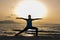 Young woman wearing protective surgical face doing yoga work out on the beach at sunset.