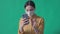 Young woman wearing a surgical mask and taking selfies