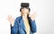 A young woman is wearing virtual reality glasses and reaching for something with his hands