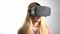 Young woman wearing VR headset .