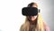 Young woman wearing VR headset .