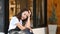 Young woman wearing waitress apron sitting out door feeling tired and fatigue.