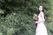 A young woman wedding photo/portrait stand by bamboos