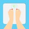 The young woman is weighed on scales. female feet with a pedicure are on an electronic balance