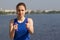 Young woman with weights exercising in the nature