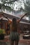 Young woman in wet clothes is happy in tropical rain