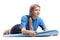 Young woman in a wetsuit lying on a surfboard