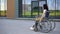 Young woman in a wheelchair. A girl rides in a wheelchair against the background of a glass building. Special transport