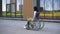 Young woman in a wheelchair. A girl rides in a wheelchair against the background of a glass building. Special transport