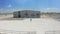 A young woman on a white Arabian horse at the equestrian club hippodrome. Aerial drone view.