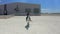 A young woman on a white Arabian horse at the equestrian club hippodrome. Aerial drone view.