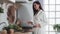 Young woman in white bathrobe cooking in kitchen at home