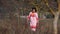 Young Woman In White Dotted Dress Walking At