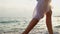 Young woman in white dress walking on beach