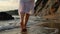 Young woman in white dress walking on beach