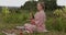 Young woman with white hair in a pink kimono plays on a singing bowl