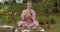 Young woman with white hair in a pink kimono plays on a singing bowl