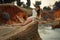 Young woman in white lacy dress lies on rock by the sea.