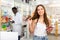 Young woman who came to the pharmacy chooses a hair care remedy