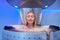 Young woman in a whole body cryotherapy cabin