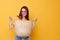 young woman wicker bag in hand pink glasses yellow background