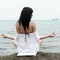 Young woman on wild rocky seashore