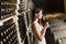 Young woman in the wine cellar